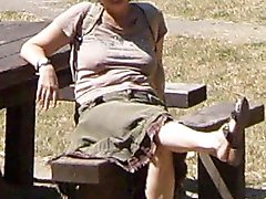 Adorable aged mama is walking on the street