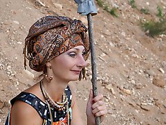 With spear wearing in colorful dress